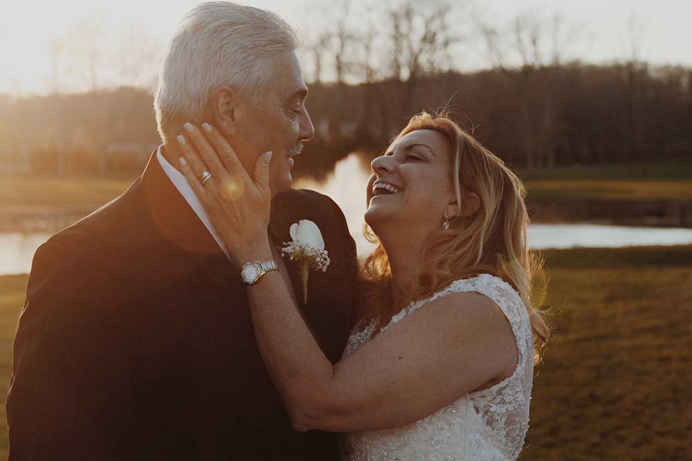 Older couple at a wedding, smiling and looking at each other