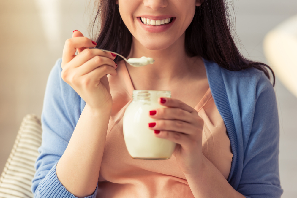 young woman eating yogurt