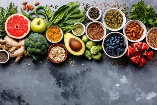 an array of healthy foods, from avocados to berries to seeds and more