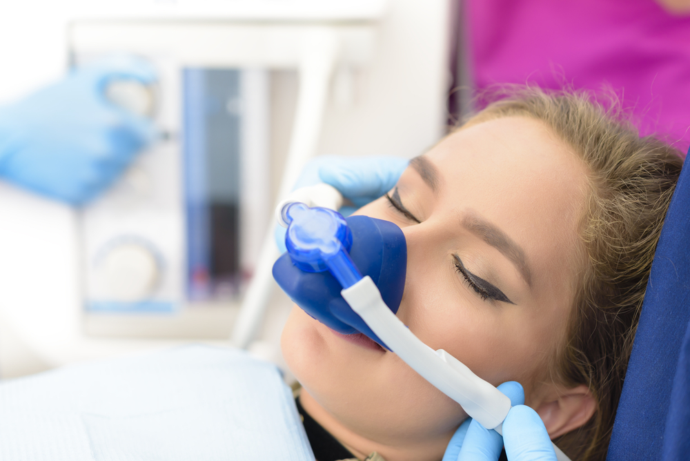 Young woman receiving nitrous oxide gas at the dentist