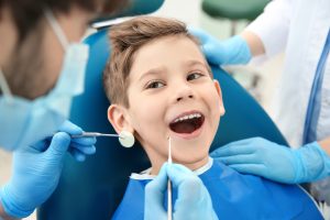 young boy getting his teeth checked at the dentist