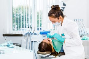 dentist performing a dental treatment on a patient