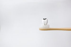 illustrated cracked tooth sitting on a toothbrush
