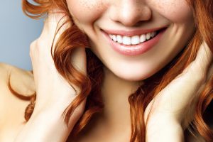 red head smiling and showing off her bright pearly whites