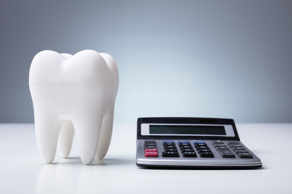 calculator and fake tooth model