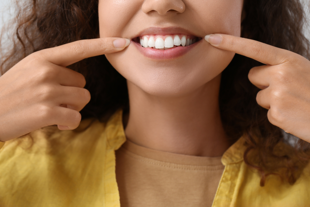 woman pointing to her healthy gums