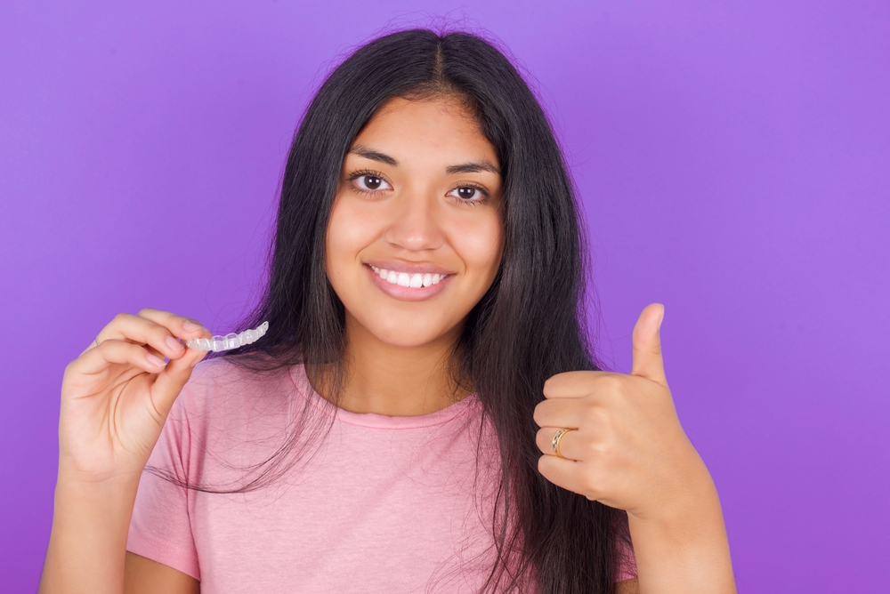 young teen using Invisalign