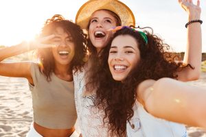 three girls laughing and showing off their smiles
